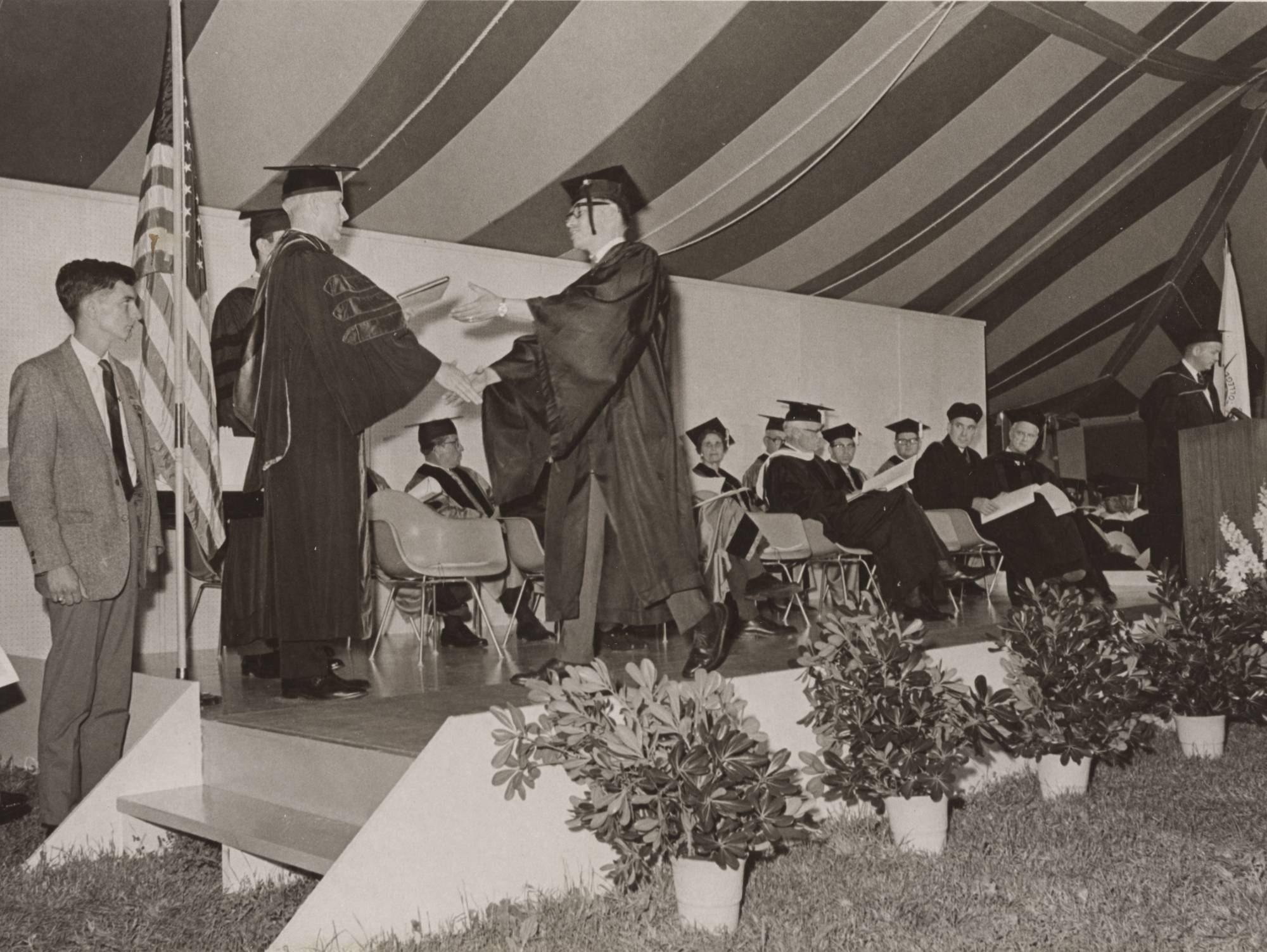 GV President handing out a graduates diploma.